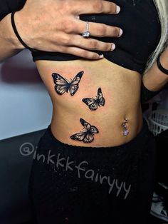 a woman's stomach with three butterflies tattooed on her belly and the words ink fairy written