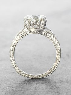 an antique style diamond engagement ring with filigrees