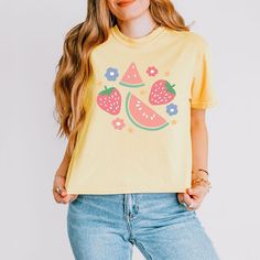 Looking for a cute versatile top to wear? Make sure to grab one of our Graphic tees! This soft and comfortable graphic tee is the perfect top for any outfit. It can be paired with biker shorts, jeans, or even a simple skirt/dress! This tee is true-to-size, so be sure to order your regular t-shirt size! If you are looking for a more oversized look, make sure to size up! Funny Print Graphic Tee Cropped T-shirt, Playful Cotton T-shirt For Spring, Summer Cropped T-shirt With Funny Print And Crew Neck, Cute Crew Neck Tops For Spring, Retro Crew Neck Cropped T-shirt For Summer, Trendy Short Sleeve Tops With Fruit Print, Cute Short Sleeve Relaxed Fit Tops, Cute Relaxed Fit Short Sleeve Tops, Trendy Crew Neck Top With Graphic Printing