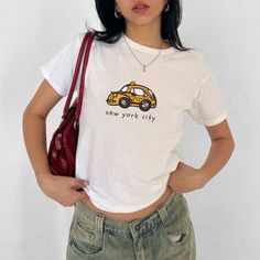 NYC Taxi Graphic Baby Tee  💕 ABOUT - The same baby-tee fit you know & love! - Super comfortable and soft material. - 100% sustainably sourced ring-spun cotton, coloured with OEKO-TEX certified low-impact dyes. - All t-shirts come with pearlized, tear-away labels for total comfort and a scratch-free experience. 🌟SIZING - Please find the size chart in the description before purchasing. 💖CARE/ WASH - Machine wash: warm 30C (max 40C or 105F) - Non-chlorine bleach as needed - Tumble dry: low temp Nyc Graphic, Nyc Taxi, New York Taxi, Graphic Baby Tee, Baby Crop Top, Baby Graphic Tees, Y2k Baby Tee, Lazy Day Outfits, Summer Lookbook