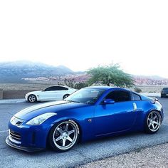 a blue sports car parked in a parking lot