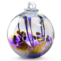 a glass vase with purple flowers in it