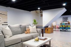 a living room filled with furniture and a white coffee table in front of a couch