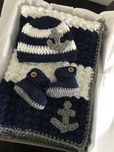 a crocheted blanket and hat set in a box