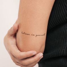 a woman's arm with a tattoo that reads, believe in yourself on it