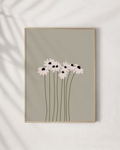 a painting with white and black flowers in it on a wall next to a plant