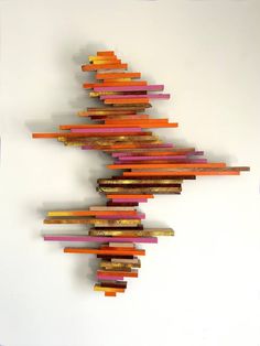 an art piece made out of colored sticks