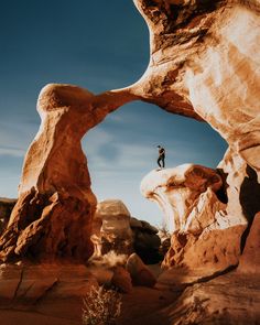 a man standing on top of a large rock formation