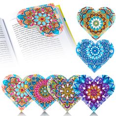 an open book with four different designs on the pages and one in the shape of a heart