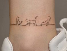 a woman's ankle with three cats on it and the word love written in black ink