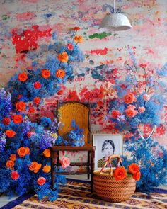 a room with flowers on the wall and a chair