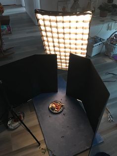 the lighting is set up in front of an empty chair with food on it,