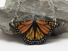 "This nature inspired monarch butterfly pendant in black and orange would make a perfect gift for a butterfly lover. I created the image with a process called caning, where different colors of clay are pieces together, reduced down to size, and sliced.  Approximately 1 3/4\" in size with a black textured backing and a 16, 18, or 20\" stainless steel chain. More butterfly items: https://www.etsy.com/shop/PasticheAccessories?ref=hdr_shop_menu&search_query=Butterfly" Polymer Clay Nature, Butterfly Items, Clay Nature, Black Polymer Clay, Necklace Orange, Space Jewelry, Hiker Gifts, Anniversary Necklace, Butterfly Pendant Necklace