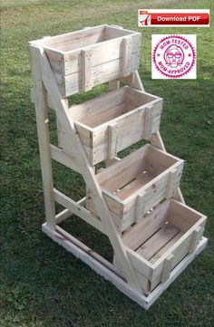 three wooden crates stacked on top of each other in the grass with an award badge above them