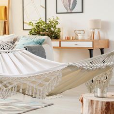 a white hammock hanging in a living room