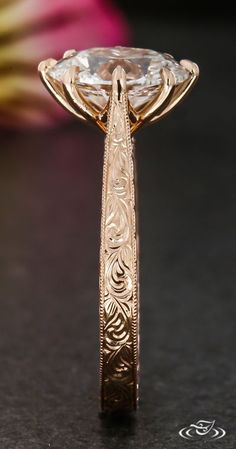 a close up view of a ring with an intricate design on the front and side