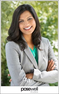 a woman with her arms crossed smiling