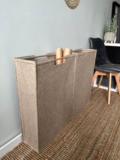 a room with a chair, table and storage bin