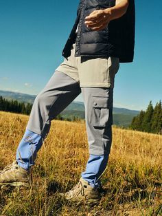 a man standing on top of a grass covered field