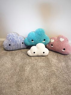 four stuffed animals are lined up on the floor