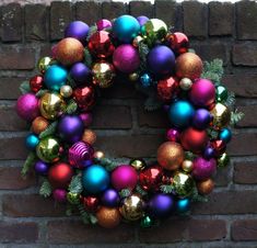 a christmas wreath is hanging on a brick wall