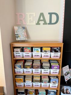 a bookshelf filled with lots of books next to a sign that reads read