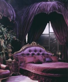 a bedroom with purple bedding and curtains