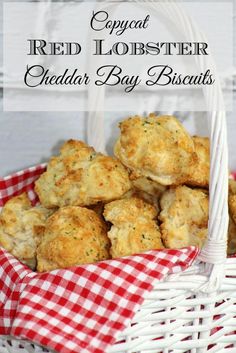 a basket filled with cheddar bay biscuits on top of a red and white checkered table cloth