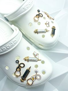 pair of white shoes with scissors and combs on them