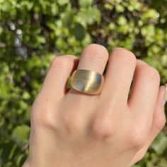 Vintage 18KT yellow gold + white gold mid-century modernist domed cigar band ring with circles design. Matte-finished, dual metal gold, with yellow gold band and white gold circles. A rare, absolutely statement-getting piece made in high-quality 18K gold! A ring with pedigree- originally purchased from premier Minneapolis, MN jeweler, Morgan Jeweler's, circa 1970's. Coordinating bracelet sold separately. Beautiful, chunkiness to this piece! Size 5.25 Width: 14mm at widest point ~5mm (back band) Modern Gold Wide Band Domed Ring, Modern Gold Wide Band Ring With Domed Shape, Modern Yellow Gold Domed Signet Ring, Modern Gold Wide Band Oval Ring, Modern Gold Dome Ring For Anniversary, Modernist Dome Ring With Polished Finish, Modernist Oval Gold Jewelry, Polished Modernist Dome Ring, Modern Yellow Gold Dome Ring With Polished Finish