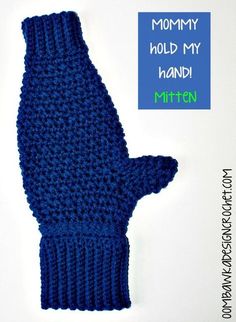 a blue knitted mitten with the words mommy hold my hand written on it