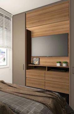 a bedroom with a bed, dresser and television on the wall in front of a window