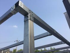 a metal pole with some wires attached to it and blue sky in the back ground