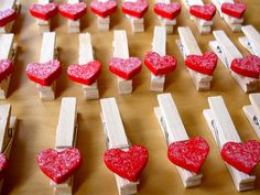 red hearts are placed on wooden clothes pins