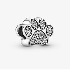 Brand New Sparkling Paw Print Charm Pandora Ale S925 Celebrate Your Favorite Four-Legged Friend With This Pandora Paw Print Charm. Finely Crafted In Sterling Silver, This Adorable Charm Is Embellished With Sparkling Cubic Zirconia Stones. A Delightful Gift For Any Cat Or Dog Lover, It Will Add Whimsical Charm To Your Pandora Jewelery Collection. Pandora Cat Charm, Pandora Dog Charm, Paw Pad, Pandora Flower, Pandora Jewelry Charms, Cupcake Charms, Pandora Pink, Paw Print Charm, Dog Charms