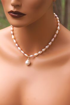 P320 Pearls are the symbol of New beginnings, June birthstone and 30th anniversary. Pearls are the most elegant and versatile accessory in a lady's armoire, they do not have to be reserved for special occasions anymore and can be perfect jewelry for any attire.  Pearls are great wedding jewelry that can be passed down to the next generation. Specs: Center Pearl type: Edison Baroque Pearl  Central Pearl size: Approximately 15x12mm  Pearl strand type: Genuine Freshwater Pearl color: Intense Gold with some and Pink undertones Shape: Pear shape  Necklace Pearl Size: Approximately 11x7mm Chain Metal: 14KYGF Chain length: 16 inches with 18.5 bottom pearl drop  Professional settings and high-resolution cameras have been used to photograph this incredible jewelry, colors may vary from monitor to m Elegant Pear-shaped Pearl Necklace, Elegant White Pear-shaped Pearl Necklace, Elegant Heart-shaped Pearl Chain Necklace, Elegant Shell-shaped Pearl Drop Necklace, Pearl White Shell-shaped Pearl Chain Jewelry, Pearl Charm Necklace, Anniversary Gift Ideas, Pearls Wedding, Great Anniversary Gifts