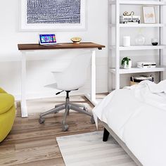 a bedroom with a bed, desk and chair next to a white book shelf filled with books