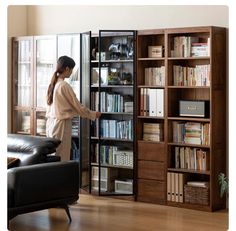 a woman standing in front of a book shelf