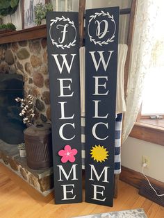 two black and white signs that say welcome to the homeowners in front of a fireplace