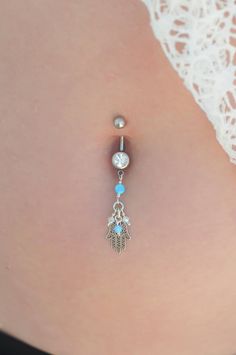 "A Hamsa belly button ring made with dangling light blue Opal stones and white Swarovski beads. This navel piercing is handmade of a Silver barbell, Hamsa hand pendant, and light blue Opal stones. The Hamsa (or Hand of Fatima) is a middle-eastern symbol of good luck, said to keep evil spirits away. Do not hesitate to contact me for special requests and customization! ♥♥ ▶ Sterling Silver curved barbell, 11 mm long for a universal fit. ▶ Delicate silver chain ▶ Light Blue Opal stones and white Sw Nickel Free Sterling Silver Dangle Belly Rings, Nickel-free Dangle Belly Rings In Sterling Silver, Nickel-free Sterling Silver Dangle Belly Rings, Adjustable Sterling Silver Dangle Belly Rings, Dainty Dangle Belly Rings As Gift, Adjustable Nickel-free Dangle Belly Rings, Dangle Body Jewelry With Charms As Gift, Sterling Silver Dangle Belly Rings For Gift, Adjustable Dangle Belly Rings As Gift