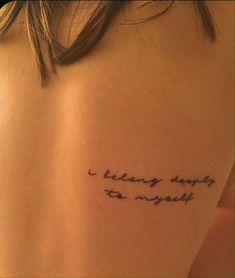 the back of a woman's shoulder with a tattoo saying i belong deeply to my world