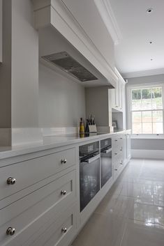 a kitchen with white cabinets and an oven