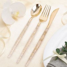 three forks and two spoons on a table