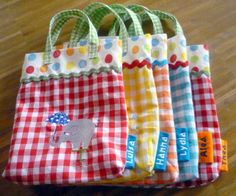 four bags with different designs on them sitting on a wooden floor next to each other