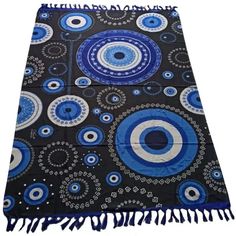 a blue and black area rug with circles on it