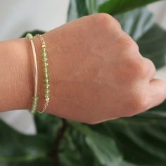 Dainty Peridot bracelet or bangle for a minimalist chic style. Peridot is the birthstone for August making it the perfect gift for her birthday! If you're doing heart chakra healing work, this is the gemstone for you! Additionally, all my jewelry is cleansed with Sage and activated with Reiki Healing energy before shipping it out to you. About PeridotThese hand-selected stones are meant to help balance and clear out the heart chakra. Peridot is a great stone for clearing out guilt and old baggag Adjustable Minimalist Beaded Bracelets For May Birthstone, Minimalist Green Beaded Bracelets For Friendship, Dainty Green Adjustable Chain Bracelet, Dainty Green Bracelets For Everyday, Adjustable Dainty Green Chain Bracelet, Handmade Everyday Bracelets For May Birthstone, Minimalist Birthstone Bangle Bracelet, Dainty Green Everyday Bracelets, Handmade Everyday Bracelet For May Birthstone