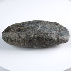 a rock sitting on top of a white table