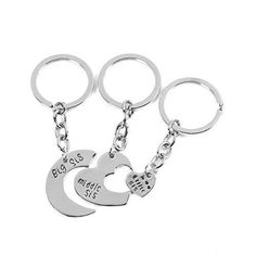 three metal key chains with two hearts on them