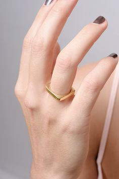 This simple yet elegant square band ring offers a timeless, minimalist design perfect for everyday styling. The slim goldtone profile has a comfortable 3.5mm height, making it an ideal stackable or everyday piece. Product Details: 18K gold plating over brass construction. Sleek, square band with a subtle geometric look. Versatile unisex style to complement any gender. The narrow shape allows seamless stacking with other rings. Designed for all-day comfort and wear. Available in a range of sizes Square Gold Ring, Ring Everyday, Sterling Silver Stacking Rings, Etsy Gold Ring, Silver Stacking Rings, Geometric Ring, Everyday Rings, Square Rings, Silver Wedding Rings