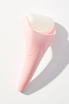 a pink toothbrush sitting on top of a white table